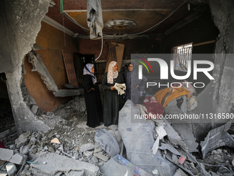 Palestinians are inspecting the damage and debris a day after an operation by the Israeli Special Forces in the Nuseirat camp, in the centra...