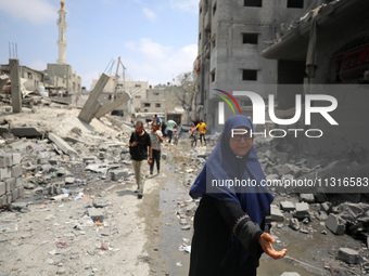 Palestinians are inspecting the damage and debris a day after an operation by the Israeli Special Forces in the Nuseirat camp, in the centra...