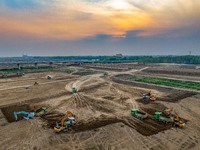 Workers are digging and cleaning the Huaihe River channel at the construction site of the second phase of the Huaihe River Waterway project...