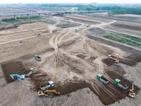 Workers are digging and cleaning the Huaihe River channel at the construction site of the second phase of the Huaihe River Waterway project...