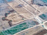 Workers are digging and cleaning the Huaihe River channel at the construction site of the second phase of the Huaihe River Waterway project...