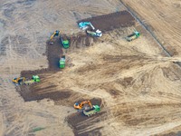 Workers are digging and cleaning the Huaihe River channel at the construction site of the second phase of the Huaihe River Waterway project...