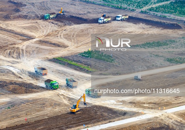 Workers are digging and cleaning the Huaihe River channel at the construction site of the second phase of the Huaihe River Waterway project...