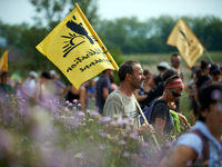 A member of the farmers' union Confederation Paysanne is holding a flag of the union. Nearly 5,000 people are participating in a weekend of...