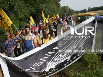 Protesters and members of the farmers' union, Confederation Paysanne, are walking towards the field which will be destroyed by the building...