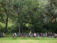 Protesters are walking near a wood. Nearly 5,000 people are participating in a weekend of action called 'Roue Libre' in the Tarn department...