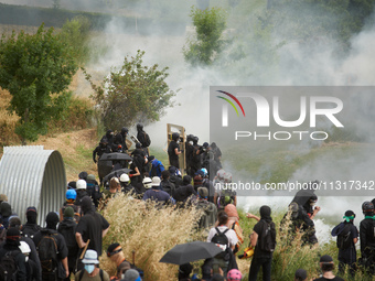 The black bloc is confronting riot police amid clouds of tear gas. Nearly 5,000 people are participating in a weekend of action called 'Roue...