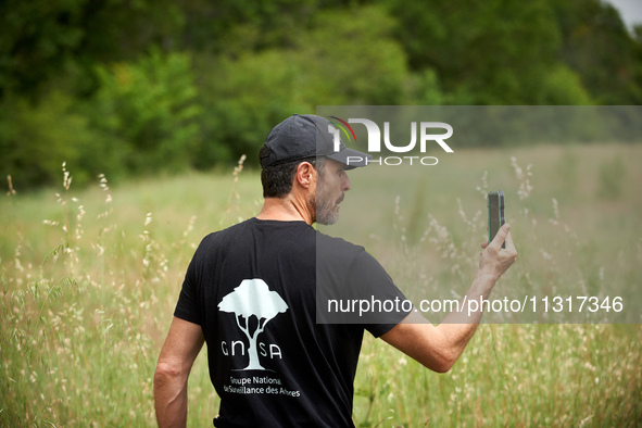 Activist climber Thomas Brail, founder of the GNSA (Groupement national de Surveillance des Arbres), is filming himself as he shows riot pol...