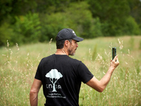 Activist climber Thomas Brail, founder of the GNSA (Groupement national de Surveillance des Arbres), is filming himself as he shows riot pol...