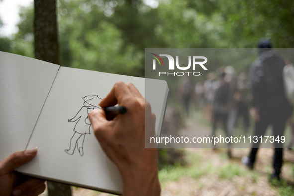 A man is drawing a black bloc member. Nearly 5,000 people are participating in a weekend of action called 'Roue Libre' in the Tarn departmen...