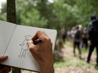 A man is drawing a black bloc member. Nearly 5,000 people are participating in a weekend of action called 'Roue Libre' in the Tarn departmen...