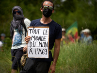 A protester is holding a placard reading 'Everyone says no to the A69'. Nearly 5,000 people are participating in a weekend of action called...