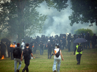 Black bloc is confronting riot police amid clouds of tear gas. Nearly 5,000 people are participating in a weekend of action called 'Roue Lib...