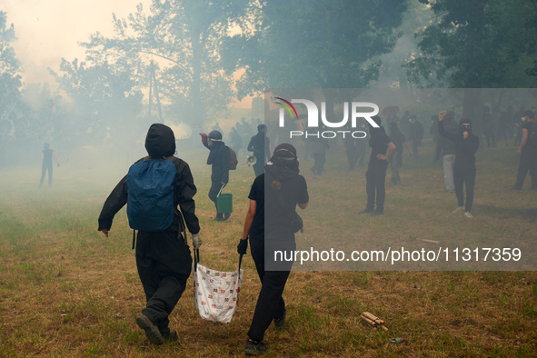 Black bloc is confronting riot police amid clouds of tear gas and smoke. Nearly 5,000 people are participating in a weekend of action called...