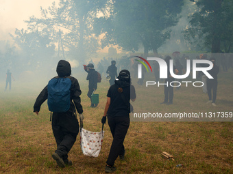 Black bloc is confronting riot police amid clouds of tear gas and smoke. Nearly 5,000 people are participating in a weekend of action called...