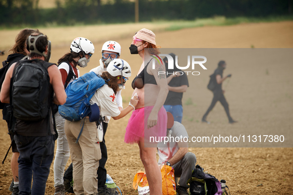 A protester is being cured by medics after being injured by a blast ball in the belly. Nearly 5,000 people are participating in a weekend of...