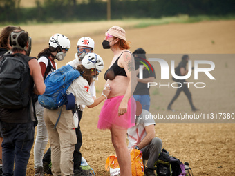 A protester is being cured by medics after being injured by a blast ball in the belly. Nearly 5,000 people are participating in a weekend of...