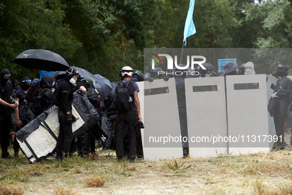 Black bloc are preparing to go to an objective of the protest. Nearly 5,000 people are participating in a weekend of action called 'Roue Lib...