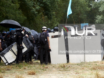 Black bloc are preparing to go to an objective of the protest. Nearly 5,000 people are participating in a weekend of action called 'Roue Lib...