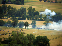 Black bloc is confronting riot police in a field during the protest. Nearly 5,000 people are participating in a weekend of action called 'Ro...