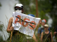 A protester is holding a flag against the A69 highway. Nearly 5,000 people are participating in a weekend of action called 'Roue Libre' in t...