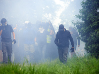 A black bloc is moving amid clouds of tear gas. Nearly 5,000 people are participating in a weekend of action called 'Roue Libre' in the Tarn...