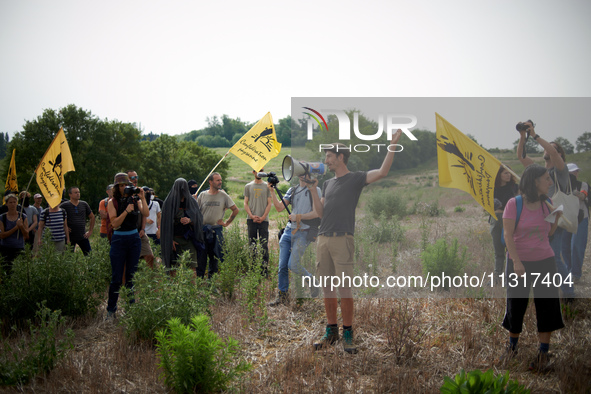 A member of the farmers' union Confederation Paysanne is making a speech in a field that will be destroyed by the A69 highway. Nearly 5,000...