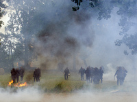 Riot policemen are amid clouds of tear gas and smoke. Nearly 5,000 people are participating in a weekend of action called 'Roue Libre' in th...