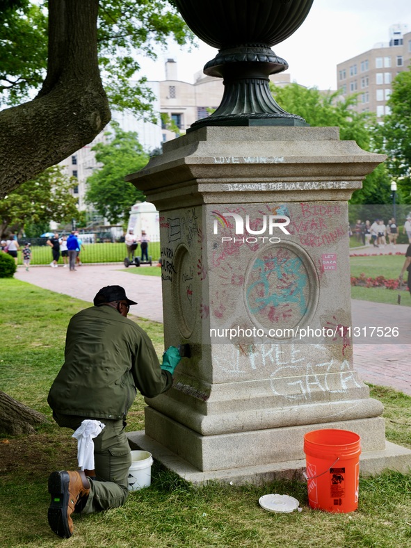 Work crews remove fences and clean statues that were covered in graffiti following a Gaza protest at the White House, in Washington, United...