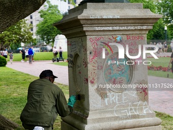 Work crews remove fences and clean statues that were covered in graffiti following a Gaza protest at the White House, in Washington, United...