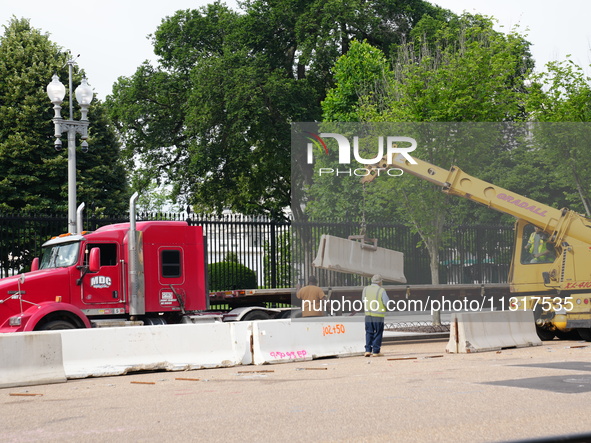 Work crews remove fences and clean statues that were covered in graffiti following a Gaza protest at the White House, in Washington, United...