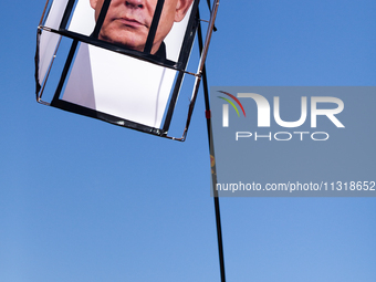 A demonstrator carries a rendition of Israeli Prime Minister Benjamin Netanyahu behind bars during a protest at the White House, Washington,...