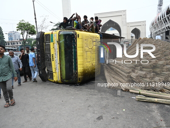 People gathered at the site of a truck accident in Dhaka, Bangladesh, on June 10, 2024. (