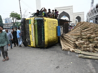 People gathered at the site of a truck accident in Dhaka, Bangladesh, on June 10, 2024. (