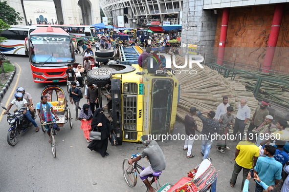 People gathered at the site of a truck accident in Dhaka, Bangladesh, on June 10, 2024. 