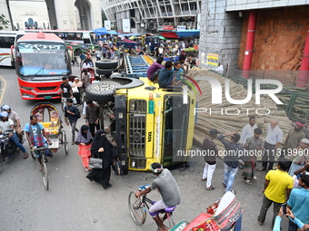 People gathered at the site of a truck accident in Dhaka, Bangladesh, on June 10, 2024. (