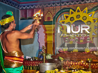 A Tamil Hindu priest is performing special prayers during the 10th night of the Pathirakali Amman festival at the Pathirakali Amman Kovil (P...