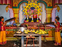 Tamil Hindu girls are using fans made of peacock feathers to fan the deities during the 10th night of the Pathirakali Amman festival at the...