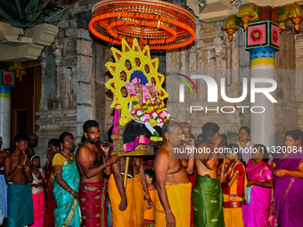 Tamil Hindu devotees are carrying the deities from the temple to the chariot outside during the 10th night of the Pathirakali Amman festival...