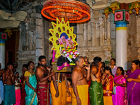 Tamil Hindu devotees are carrying the deities from the temple to the chariot outside during the 10th night of the Pathirakali Amman festival...