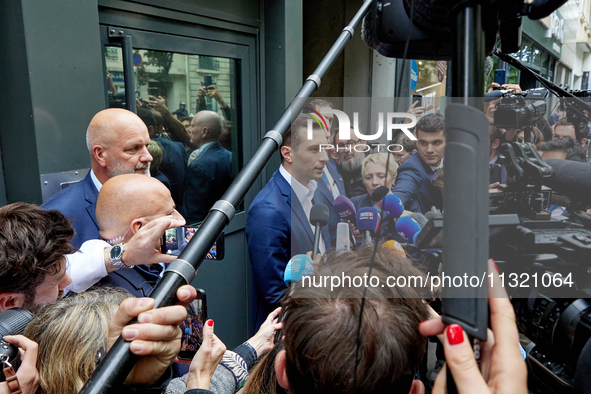 French far-right Rassemblement National (RN) party president and lead MEP, Jordan Bardella, speaks to media representatives outside the Rass...