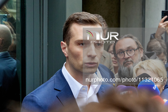 French far-right Rassemblement National (RN) party president and lead MEP, Jordan Bardella, speaks to media representatives outside the Rass...