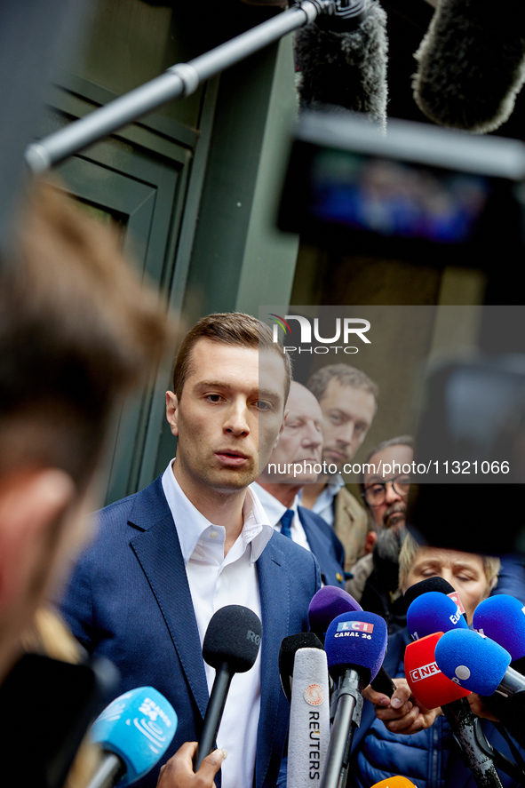 French far-right Rassemblement National (RN) party president and lead MEP, Jordan Bardella, speaks to media representatives outside the Rass...