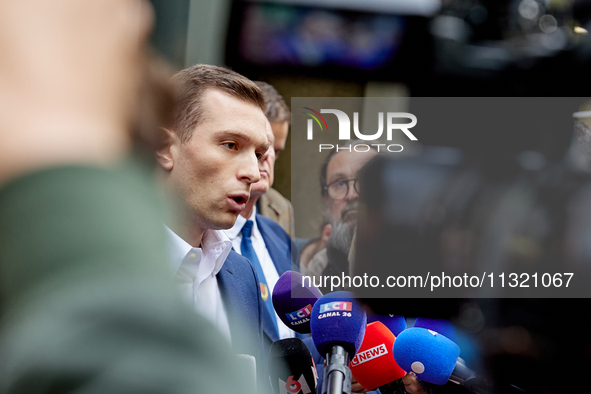 French far-right Rassemblement National (RN) party president and lead MEP, Jordan Bardella, speaks to media representatives outside the Rass...