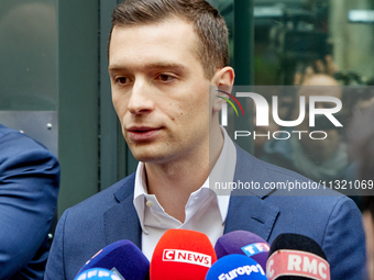 French far-right Rassemblement National (RN) party president and lead MEP, Jordan Bardella, speaks to media representatives outside the Rass...