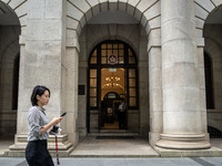 A woman is walking past the entrance of the Court of Final Appeal in Hong Kong, on June 11, 2024. (