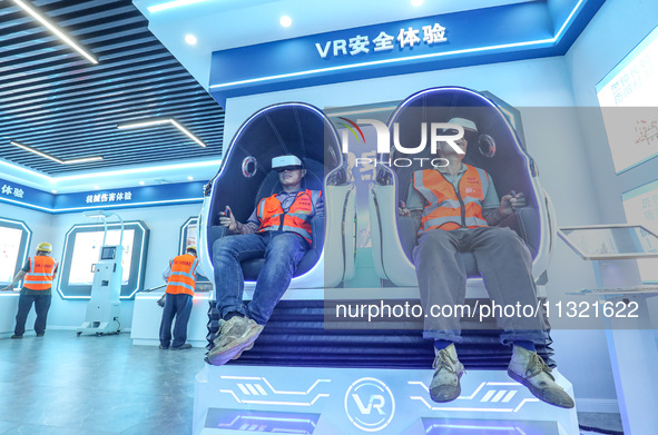 Workers are simulating a production safety accident at a VR safety experience hall in Huzhou, Zhejiang province, China, on June 11, 2024. 