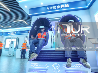 Workers are simulating a production safety accident at a VR safety experience hall in Huzhou, Zhejiang province, China, on June 11, 2024. (