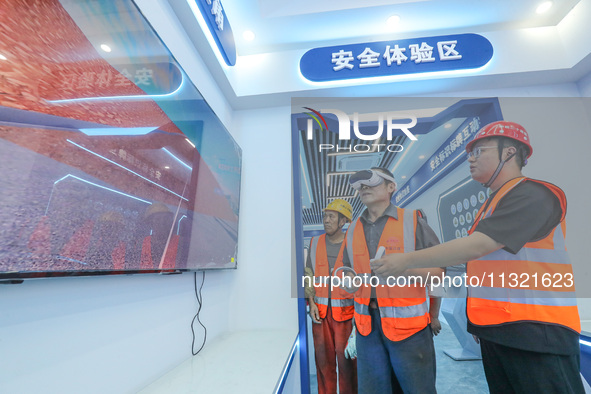 Workers are simulating a production safety accident at a VR safety experience hall in Huzhou, Zhejiang province, China, on June 11, 2024. 