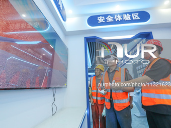 Workers are simulating a production safety accident at a VR safety experience hall in Huzhou, Zhejiang province, China, on June 11, 2024. (